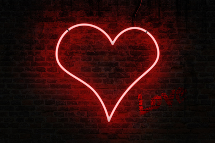 Neon heart on a brick wall