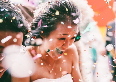 Happy bride walking through confetti